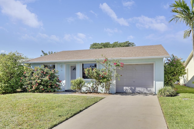 single story home featuring a garage and a front lawn