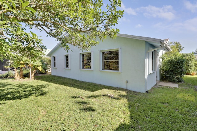 view of property exterior featuring a lawn