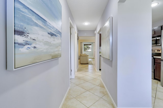 hall featuring light tile patterned floors