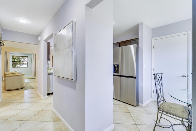 corridor featuring light tile patterned floors