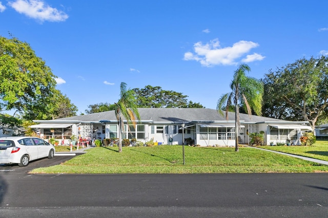 ranch-style home with a front lawn