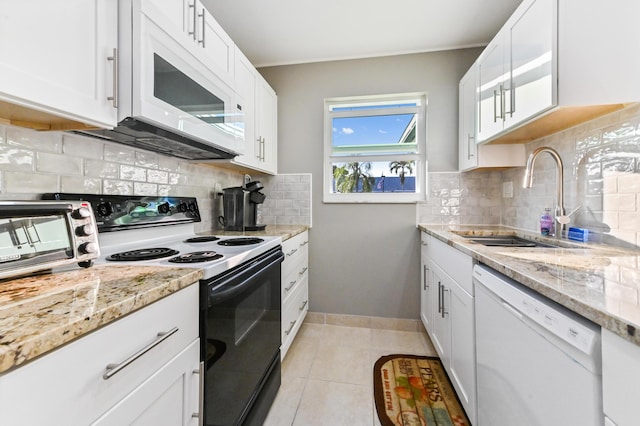 kitchen featuring white cabinets, white appliances, tasteful backsplash, and sink