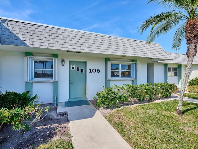 doorway to property featuring a lawn