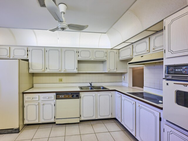 kitchen with ceiling fan, sink, backsplash, white appliances, and light tile patterned floors