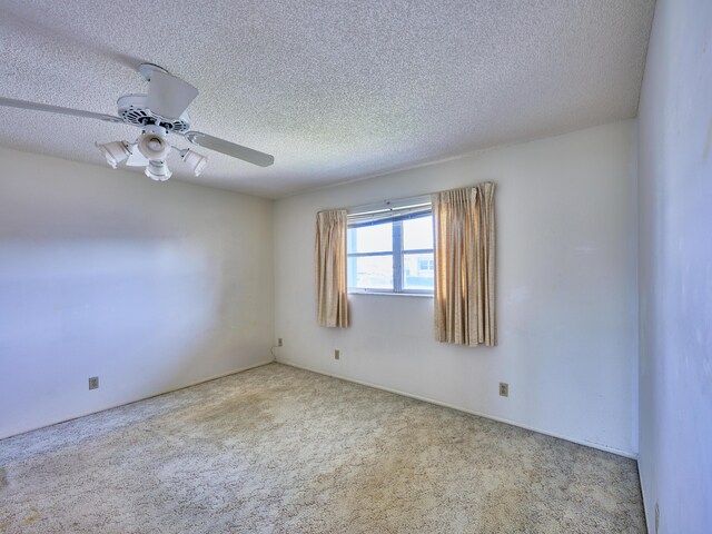 unfurnished room with light carpet, a textured ceiling, and ceiling fan