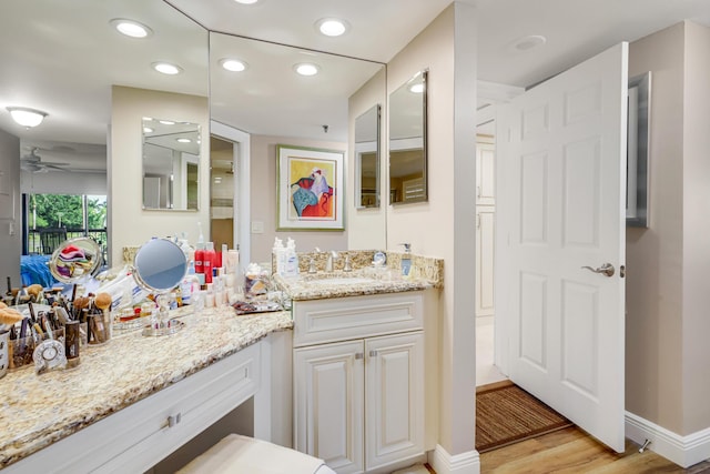 bathroom with ceiling fan, vanity, and hardwood / wood-style flooring