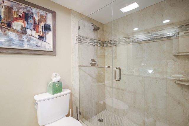 bathroom with an enclosed shower and toilet