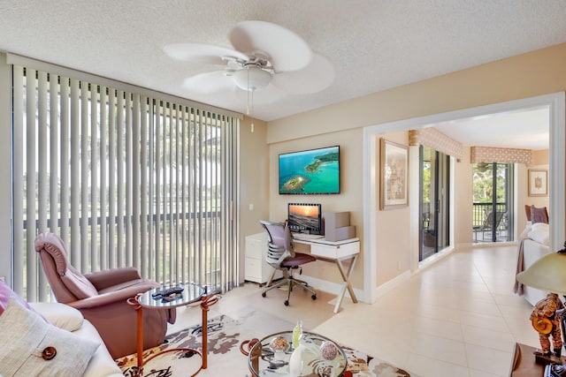 office featuring light tile patterned floors, a textured ceiling, and ceiling fan