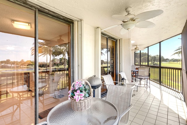 sunroom / solarium featuring ceiling fan