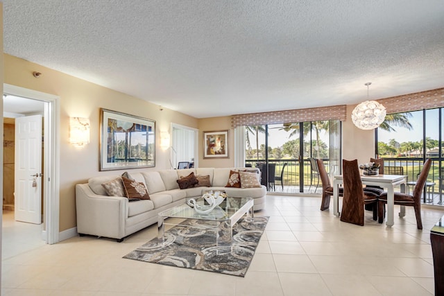 tiled living room featuring a textured ceiling and a notable chandelier