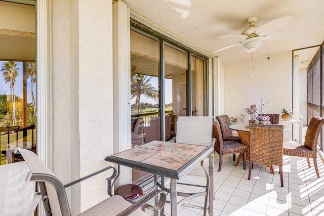 sunroom featuring ceiling fan