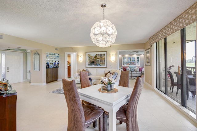 dining room featuring a chandelier and a textured ceiling