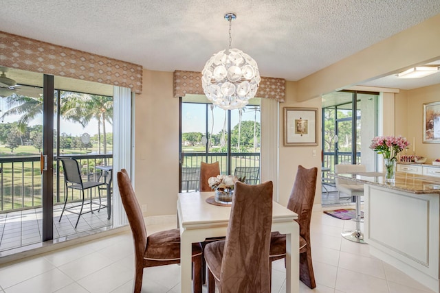 dining space with plenty of natural light, light tile patterned flooring, a textured ceiling, and an inviting chandelier