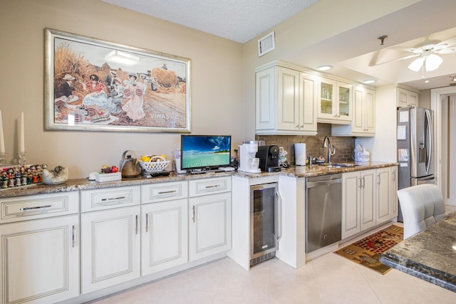 kitchen with ceiling fan, wine cooler, light tile patterned flooring, white cabinets, and appliances with stainless steel finishes