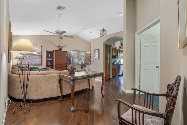 living room featuring ceiling fan, dark hardwood / wood-style flooring, and vaulted ceiling