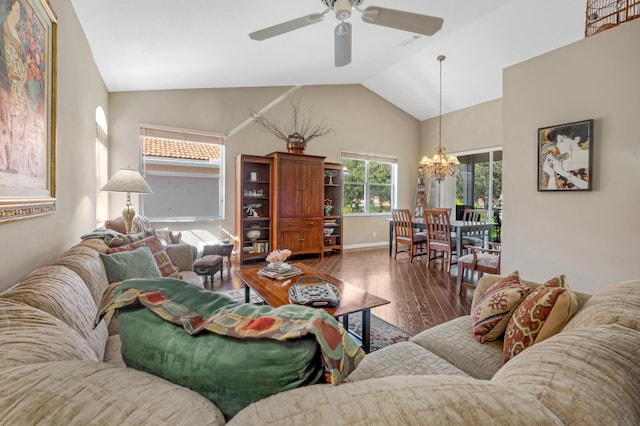 living room with dark hardwood / wood-style flooring, ceiling fan with notable chandelier, and vaulted ceiling