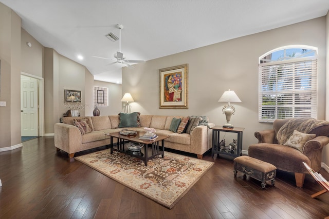 living room featuring lofted ceiling, dark wood-type flooring, and ceiling fan