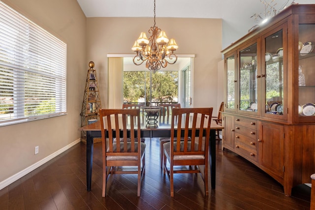 dining area featuring dark wood-type flooring and a chandelier