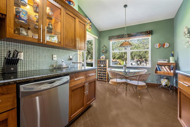 kitchen with vaulted ceiling, stainless steel dishwasher, pendant lighting, a healthy amount of sunlight, and decorative backsplash