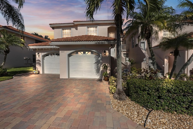 mediterranean / spanish house featuring a garage