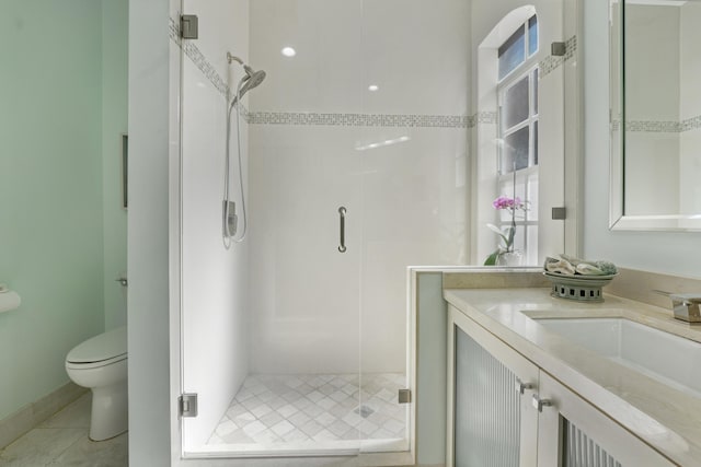 bathroom featuring vanity, toilet, an enclosed shower, and tile patterned flooring