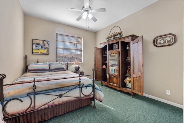 carpeted bedroom with ceiling fan and a textured ceiling