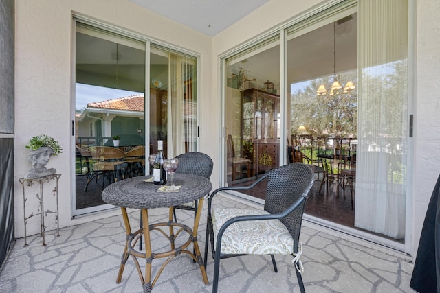 sunroom / solarium with an inviting chandelier