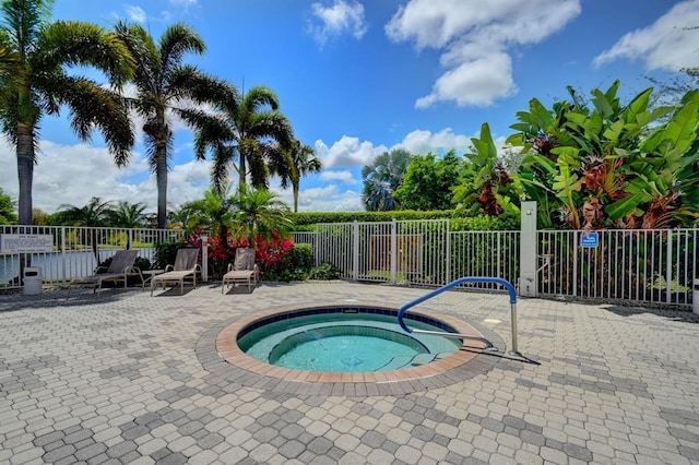 view of swimming pool with a community hot tub and a patio area