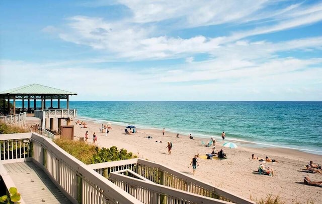 water view with a gazebo and a beach view