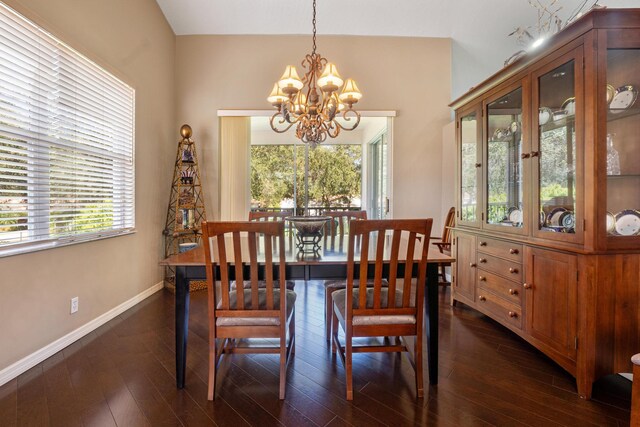 hallway with dark hardwood / wood-style floors and vaulted ceiling