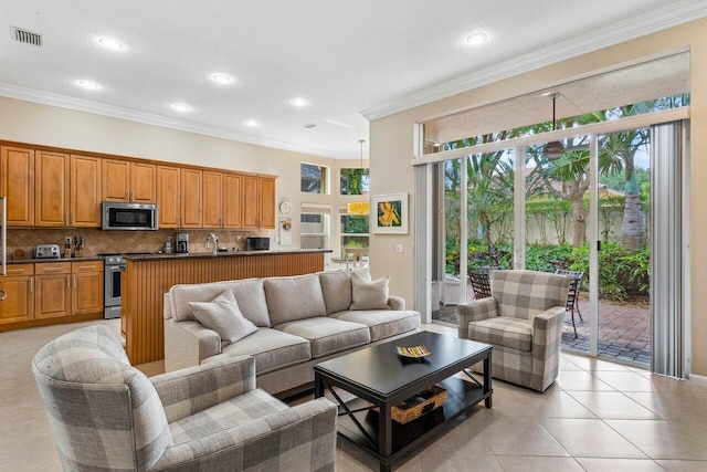 tiled living room featuring ornamental molding and sink