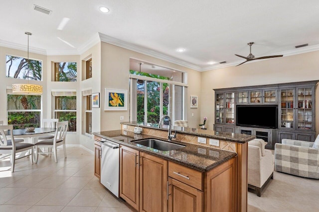 kitchen with a healthy amount of sunlight, dishwasher, sink, and hanging light fixtures