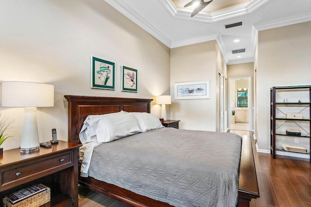 bedroom with connected bathroom, dark hardwood / wood-style floors, ceiling fan, and crown molding