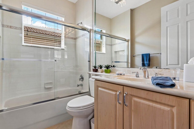 full bathroom featuring shower / bath combination with glass door, vanity, and toilet