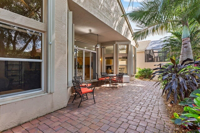 view of patio / terrace featuring glass enclosure