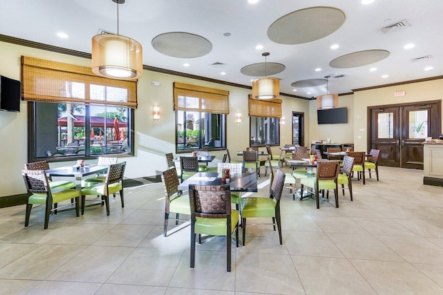 dining area featuring light tile patterned flooring and ornamental molding