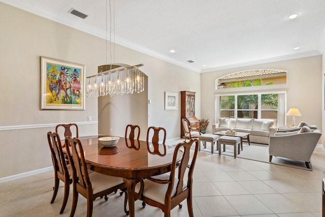 tiled dining room featuring ornamental molding, a textured ceiling, and a chandelier