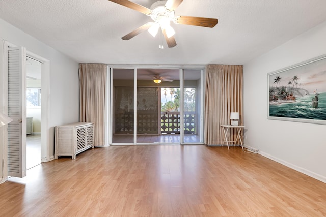 unfurnished living room with ceiling fan, light hardwood / wood-style flooring, and a textured ceiling