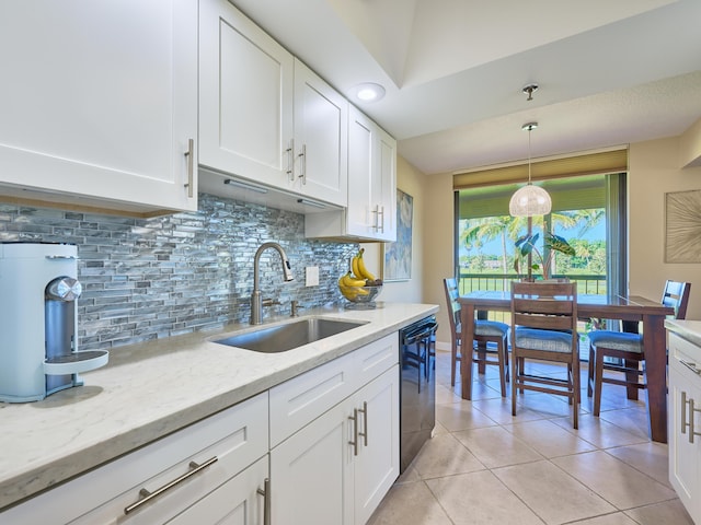 kitchen featuring dishwasher, sink, backsplash, decorative light fixtures, and white cabinets