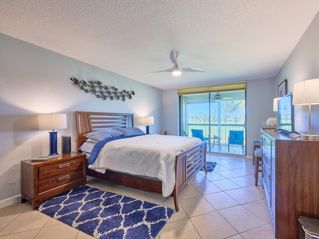 tiled bedroom with a textured ceiling, access to outside, and ceiling fan