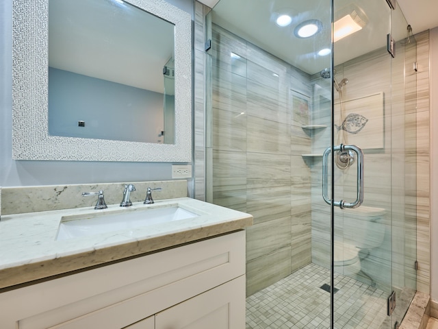 bathroom with vanity and a shower with shower door