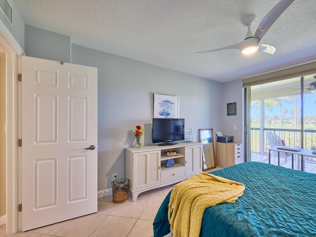 tiled bedroom featuring access to exterior, a textured ceiling, and ceiling fan