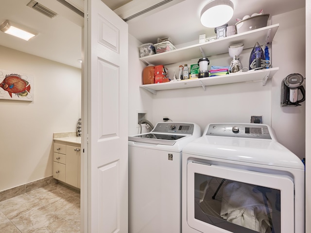 clothes washing area featuring washer and dryer