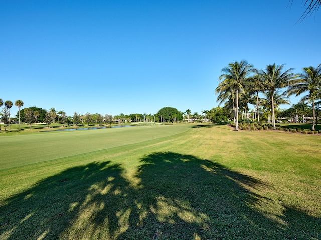 view of property's community with a lawn and a water view