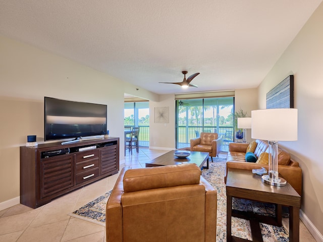 tiled living room featuring ceiling fan and a textured ceiling