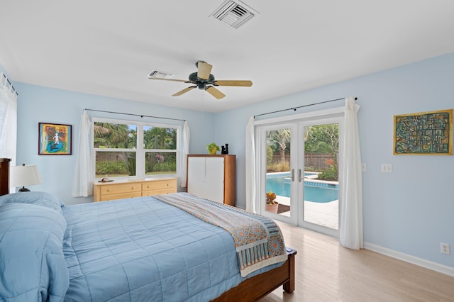 bedroom with multiple windows, ceiling fan, light wood-type flooring, and access to exterior