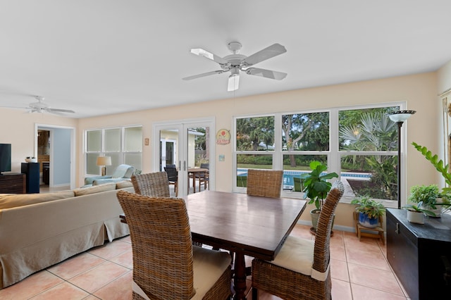 dining area with ceiling fan, french doors, and light tile patterned floors