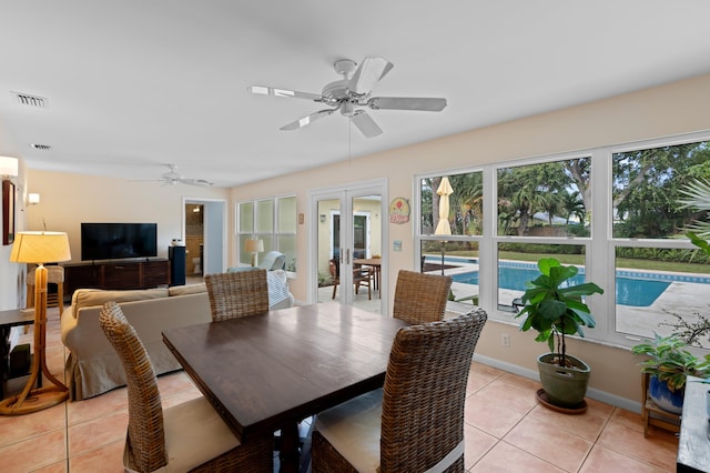 tiled dining area featuring french doors and ceiling fan