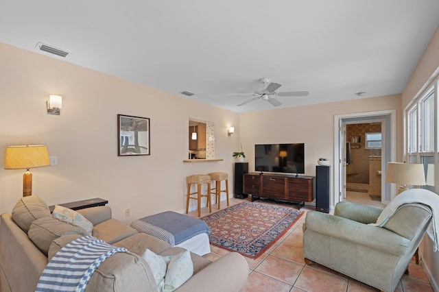 living room featuring ceiling fan and light tile patterned flooring