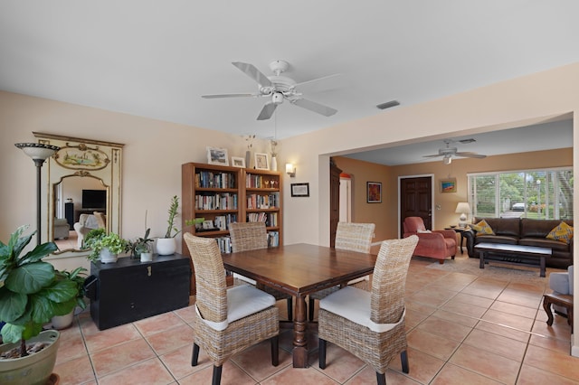 dining space with ceiling fan and light tile patterned flooring